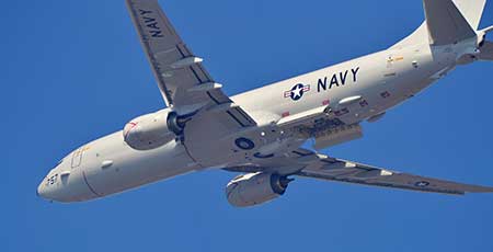 The P-8 Poseidon anti-submarine plane built by Boeing flies overhead.