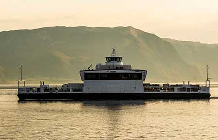 An electrified ferry crosses a fjord in Norway.