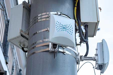 A 5G network repeater on a power pole.