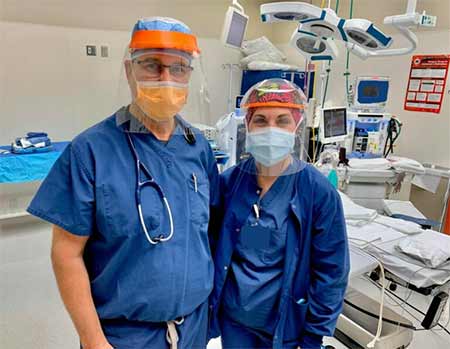 Medical professionals model a new 3D printed mask designed by Amazon.